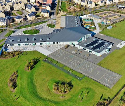 An aerial view of Ermine Street Church Academy Primary School with neighbouring homes and green space